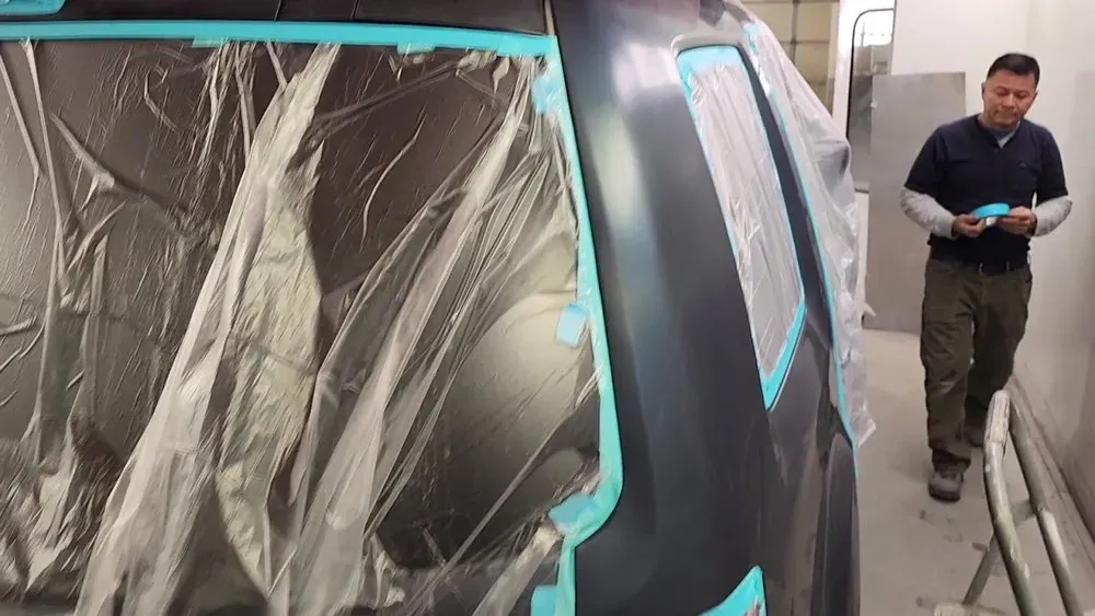 Panel masked for paint in the spray booth